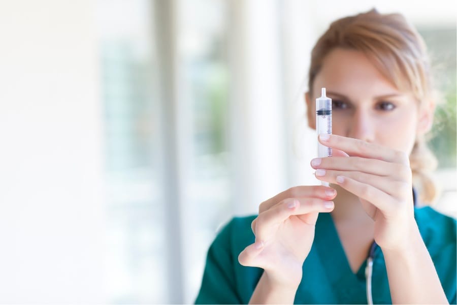 RN preparing an injection in a Stockton, California healthcare facility