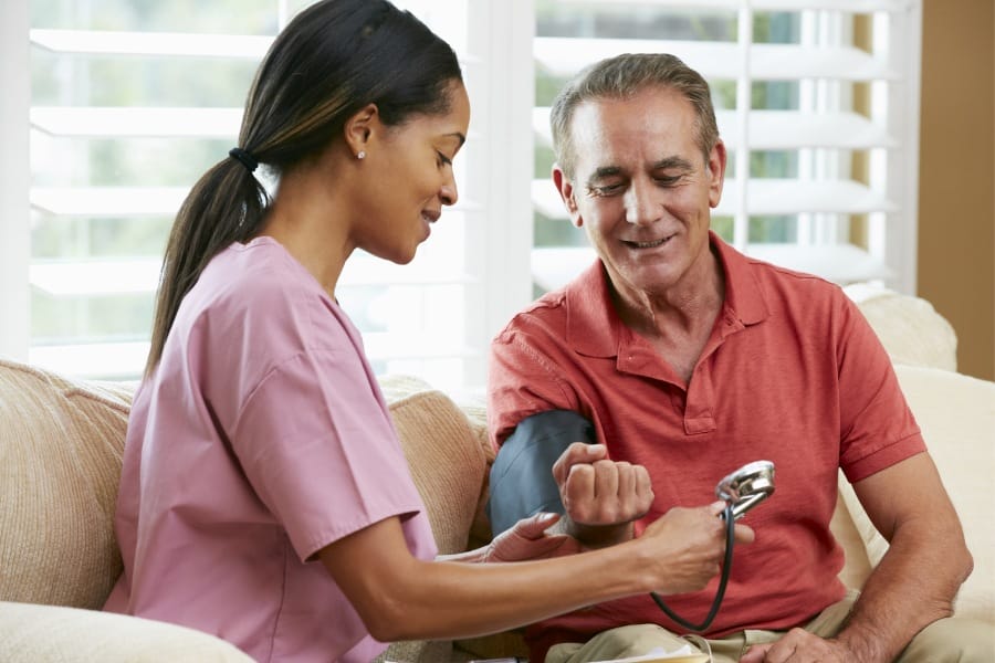nurse checking the blood pressure of a patient