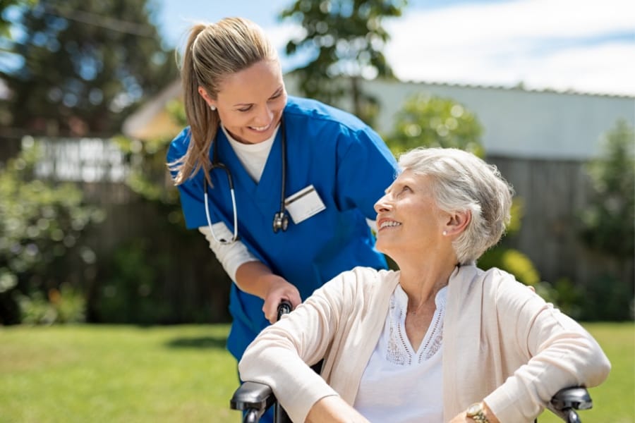 A private duty nurse and her patient with PD in a wheelchair