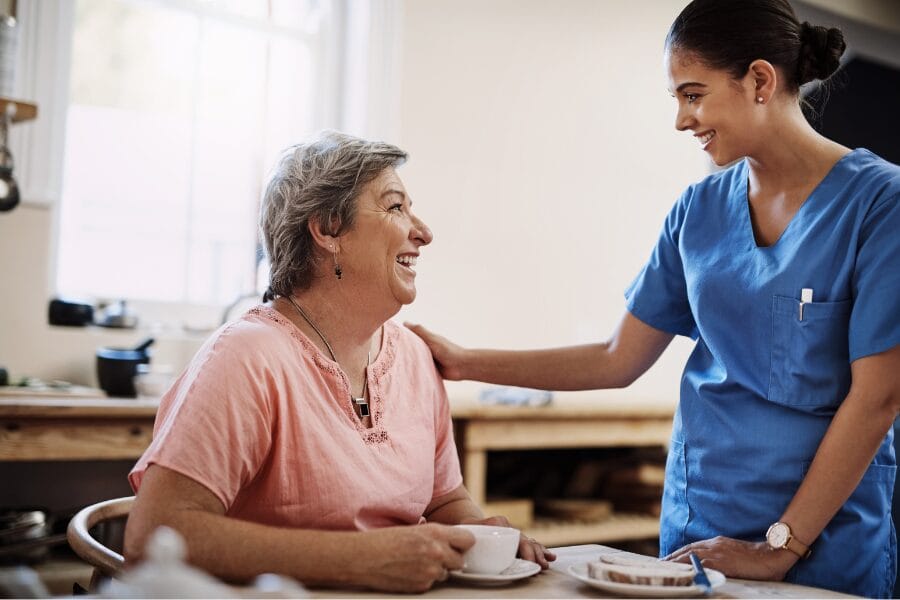 a client smiling at her private nurse