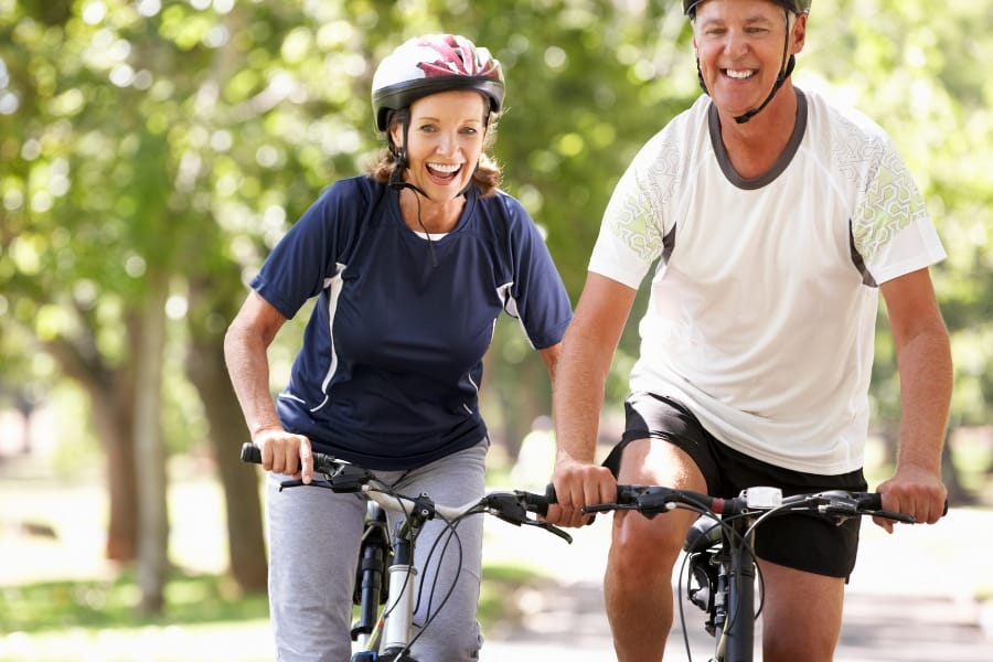 elderly couple cycling together