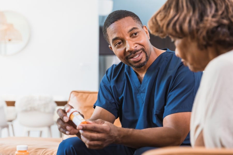 after surgery nurse offering medication to his patient