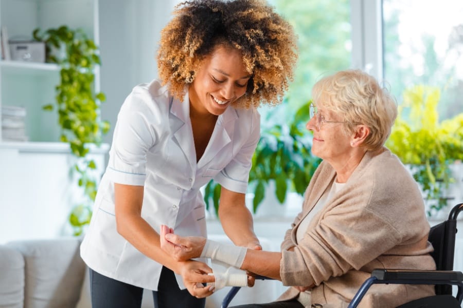 Client receiving wound care after wrist surgery