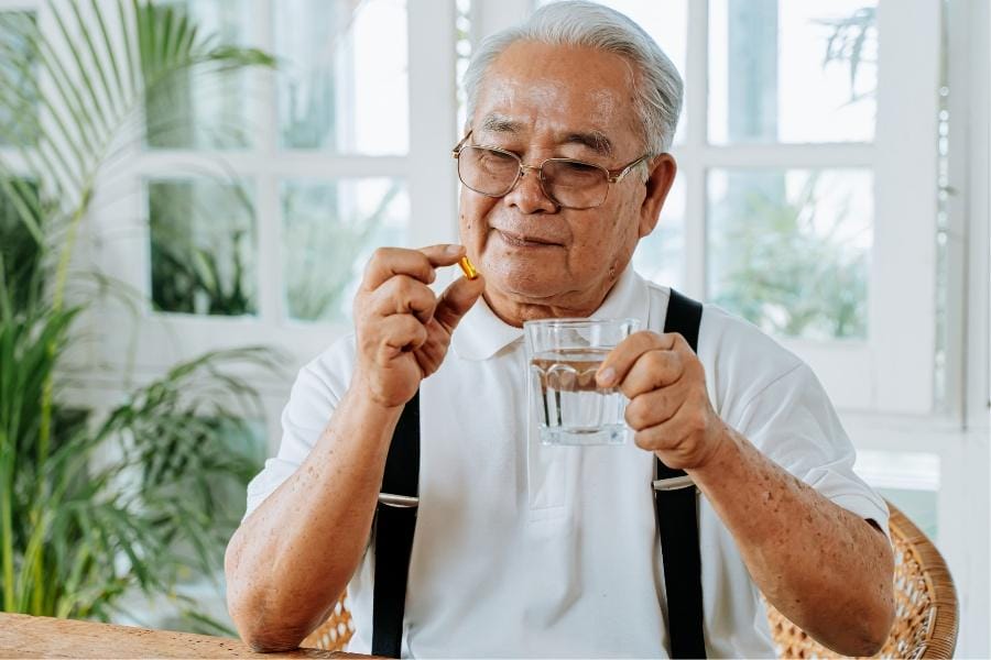 A man taking medication for Parkinson's Disease symptoms