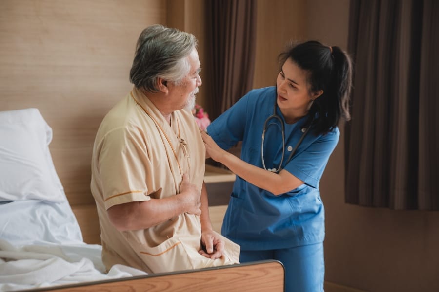 San Carlos nurse helping her patient with mobility