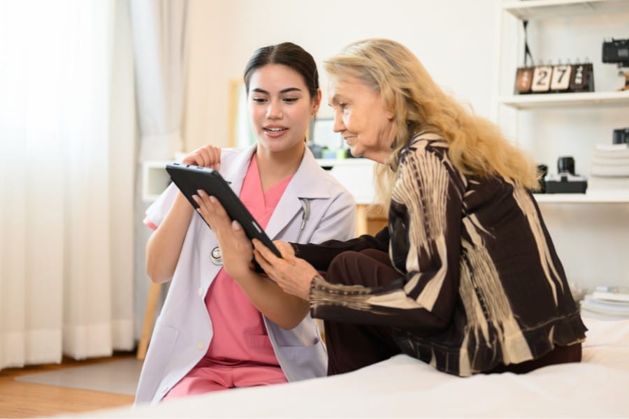 post-op nurse showing her client their patient chart