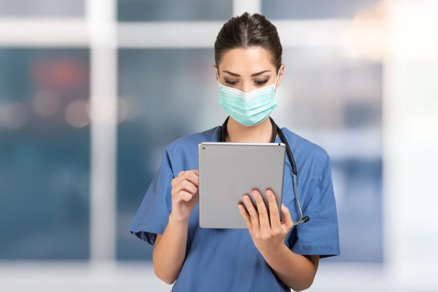 nurse holding an ipad