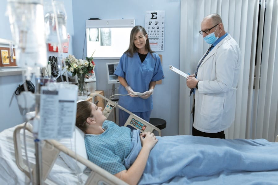 Nurse and her patient's doctor in a healthcare facility