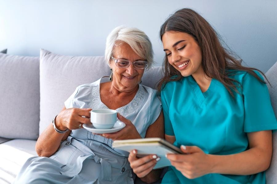 Smiling client and her private nurse