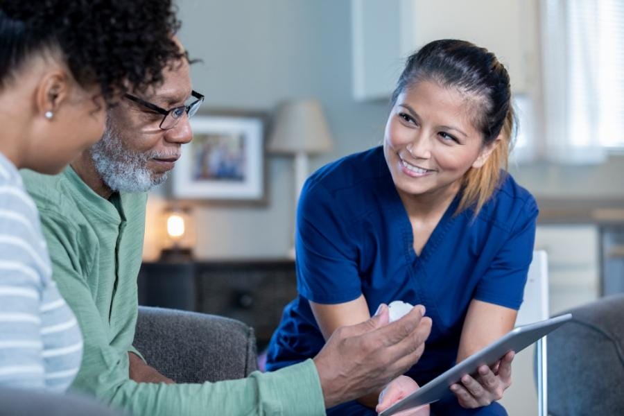 At home nurse assisting with a patient's chart