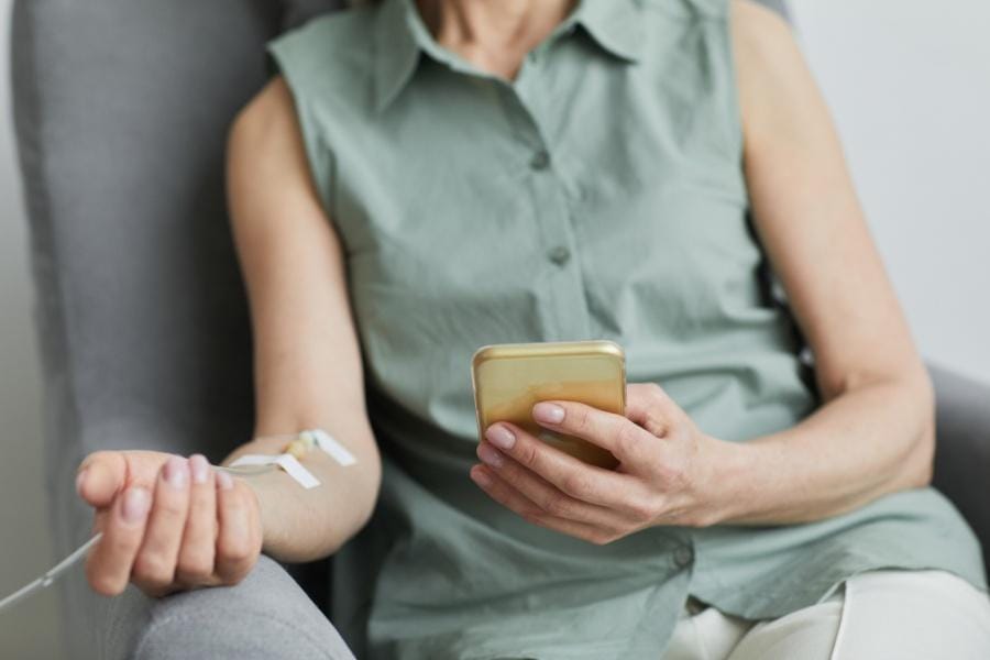 Woman receiving an IV in her home