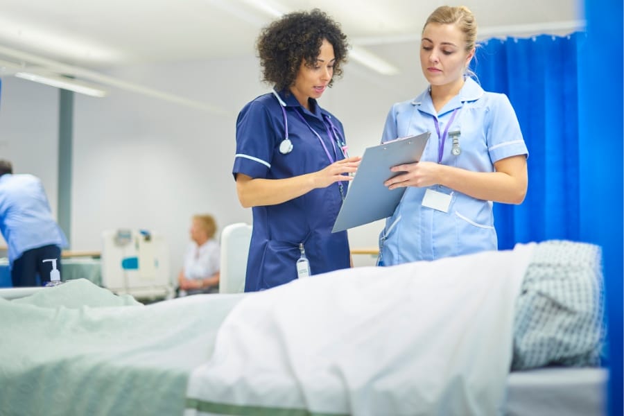 two nurses discussing a patient chart