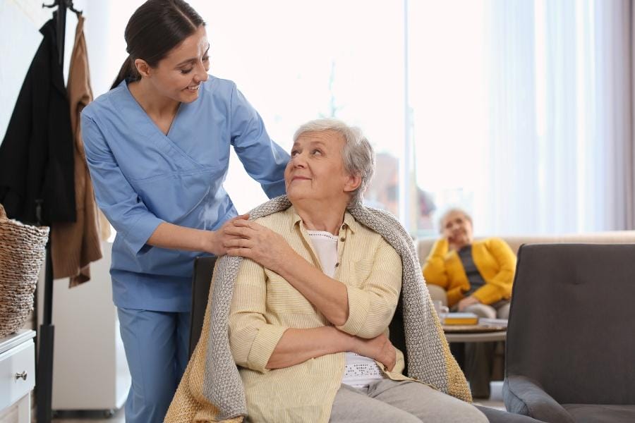 A private nurse assisting a patient with Alzheimer's