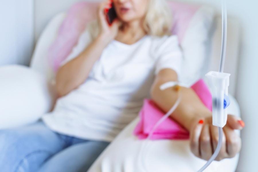 A woman on the phone while receiving medication management