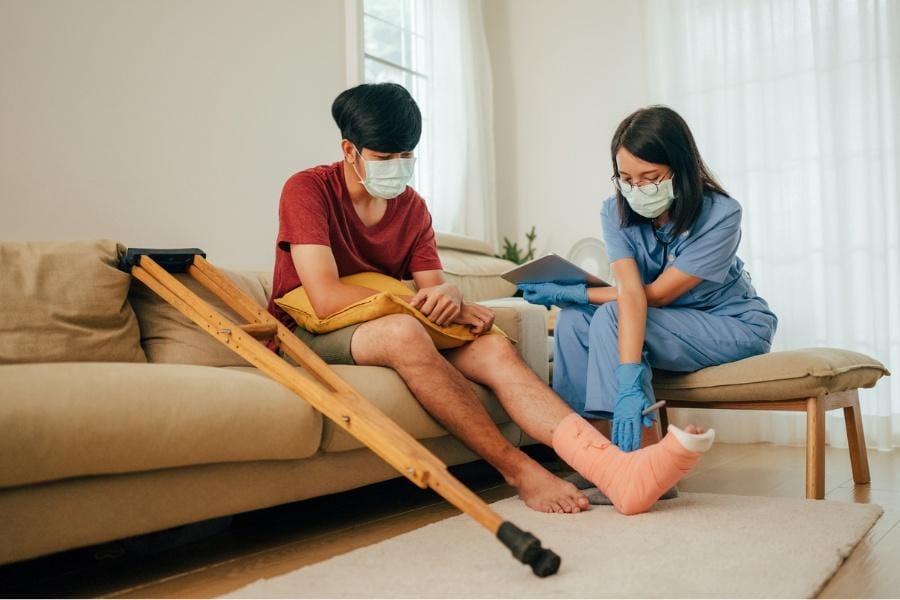 A man after surgery receiving nursing care