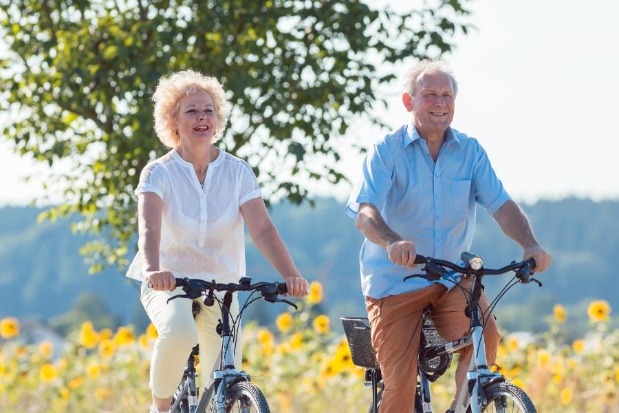 Senior couple biking with parkinson's disease