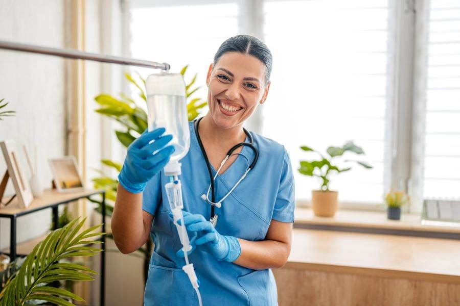 home nurse assisting with IV infusion