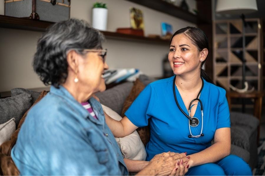 Rn assisting patient after surgery with medication