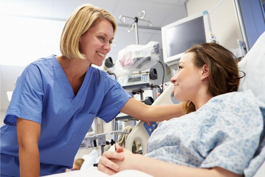 A nurse comforting a patient