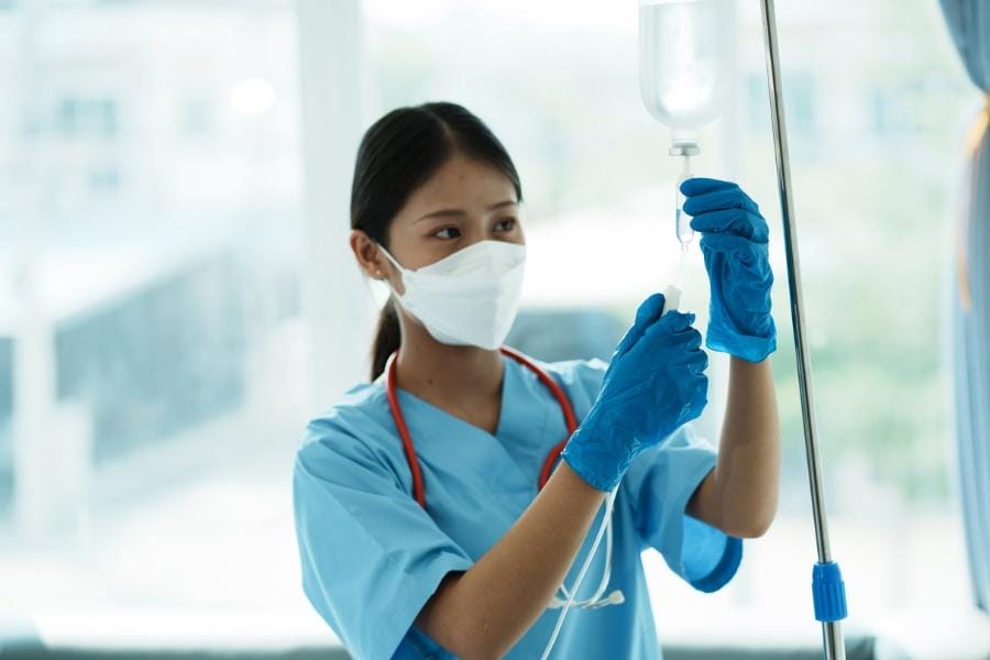 An at home nurse preparing an IV