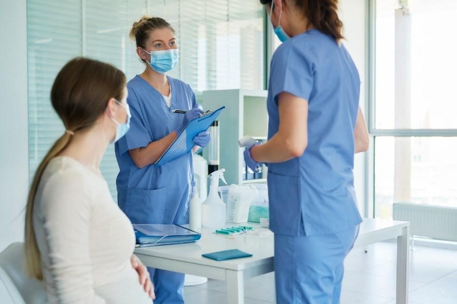 A patient and two nurses discussing their treatment