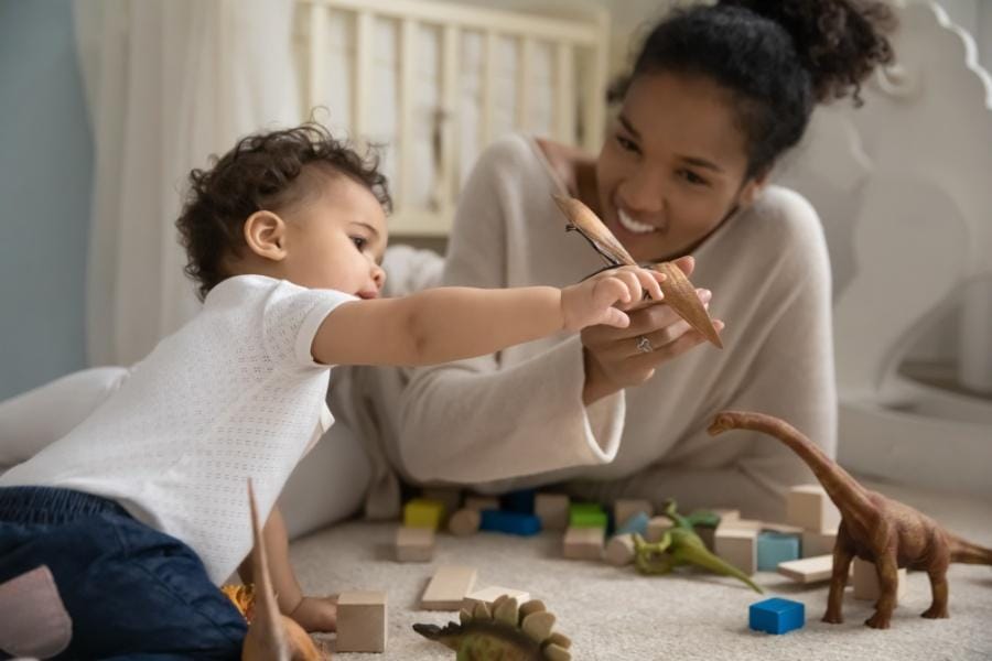 a night nanny playing with a baby