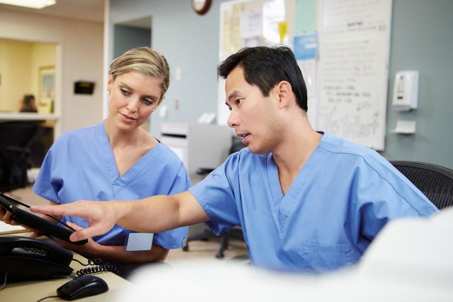 two nurses communicating about a patient