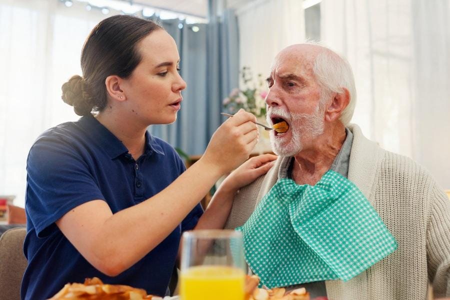 private nurse helping a PD patient eat