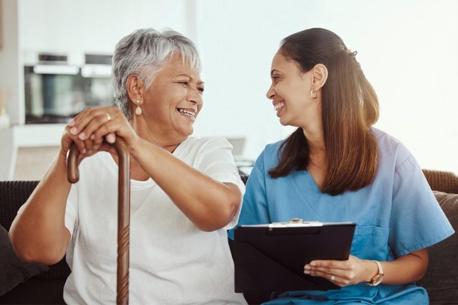 A home RN smiling with her medication management patient