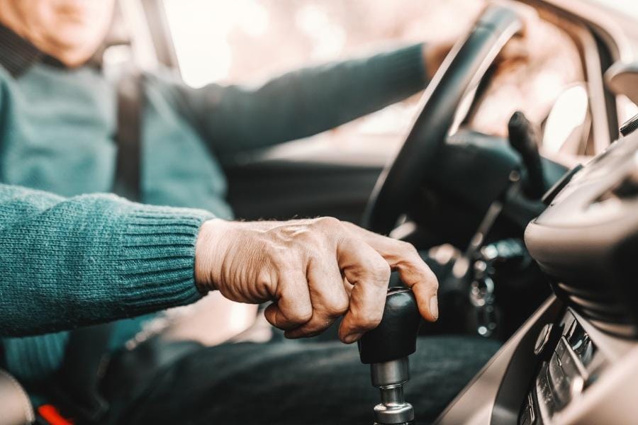 an elderly individual with PD driving