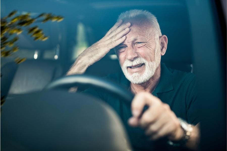 A man suffering from Parkinson's symptoms behind the wheel